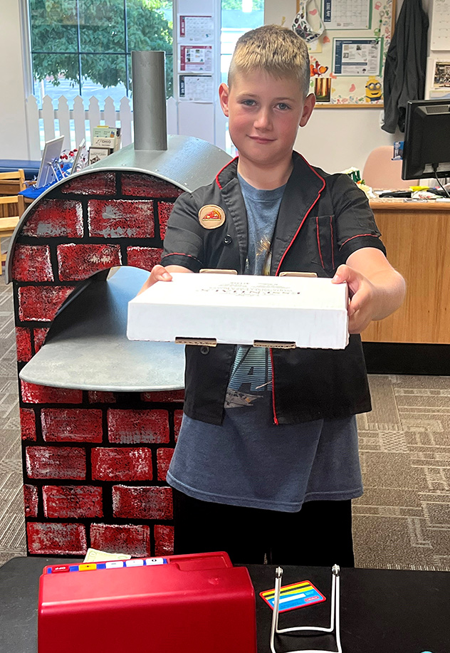 Child holding a pizza box